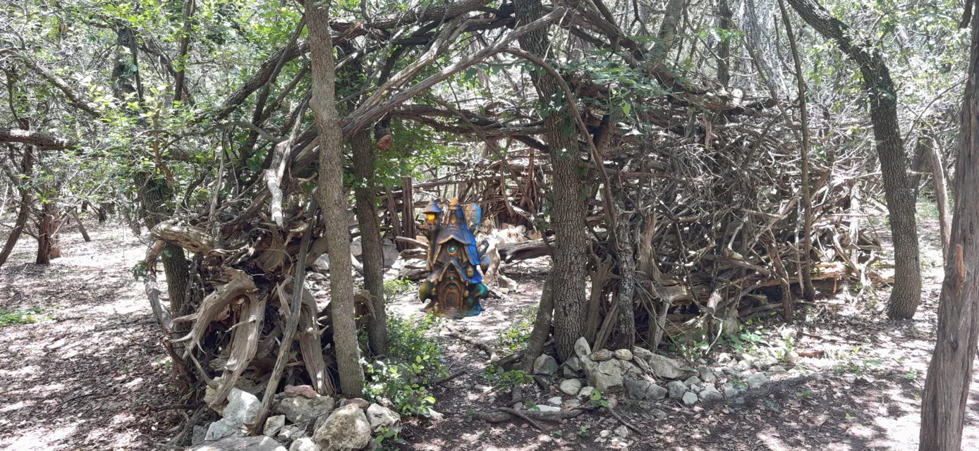 A small AR character tucked inside a tangle of forest branches