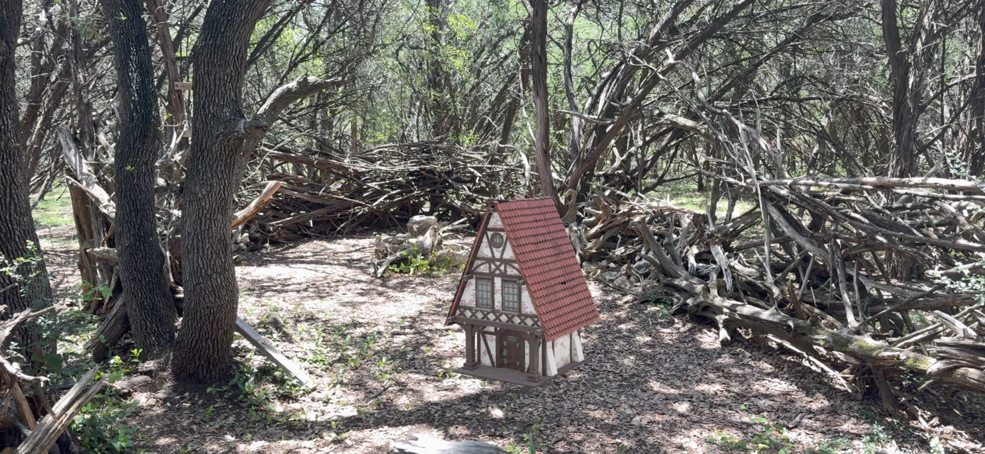A tiny chapel model discovered in AR beside a fallen tree